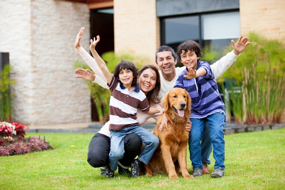 Happy family with a dog outside their house-1